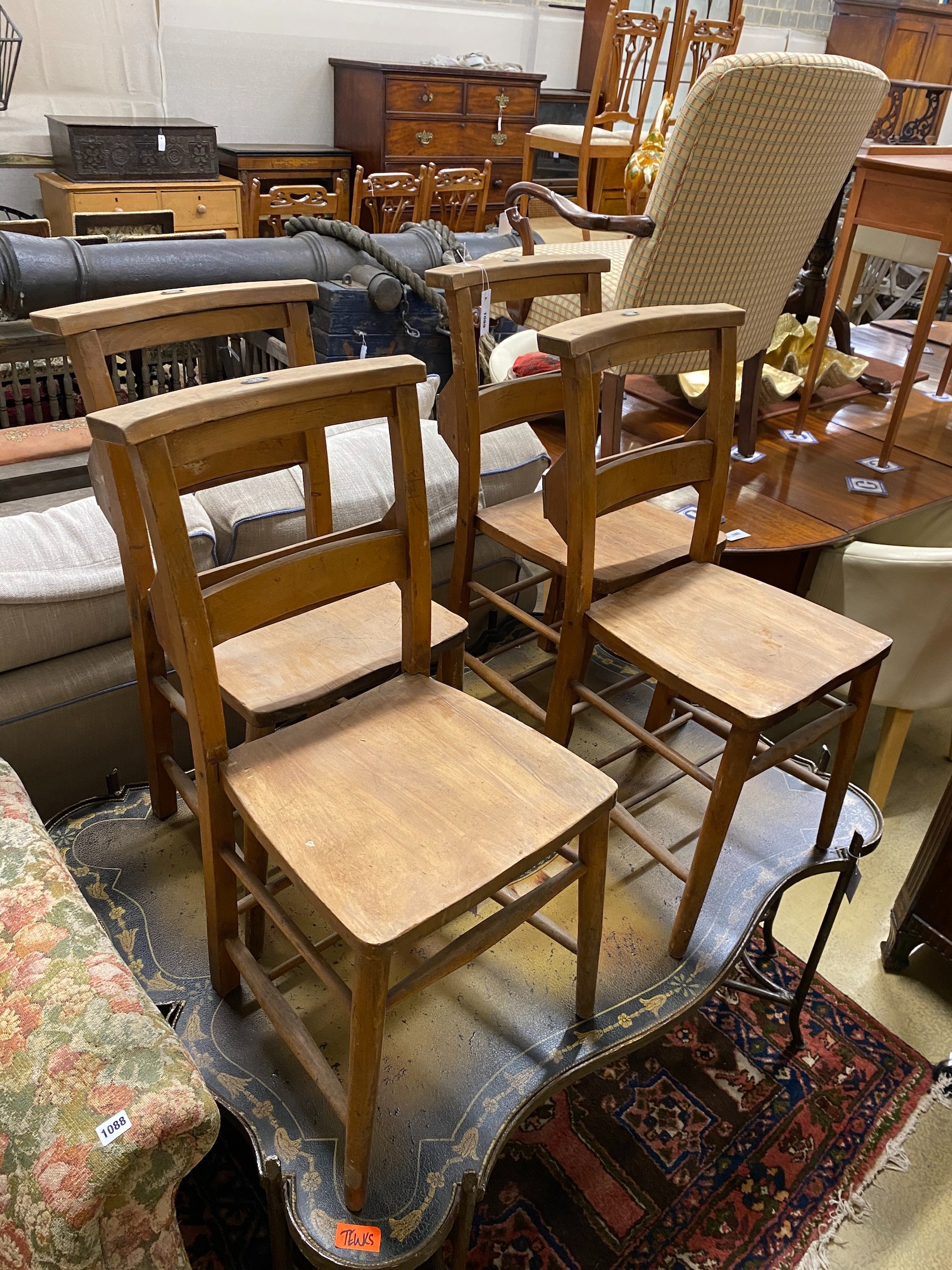 A set of four beech chapel chairs